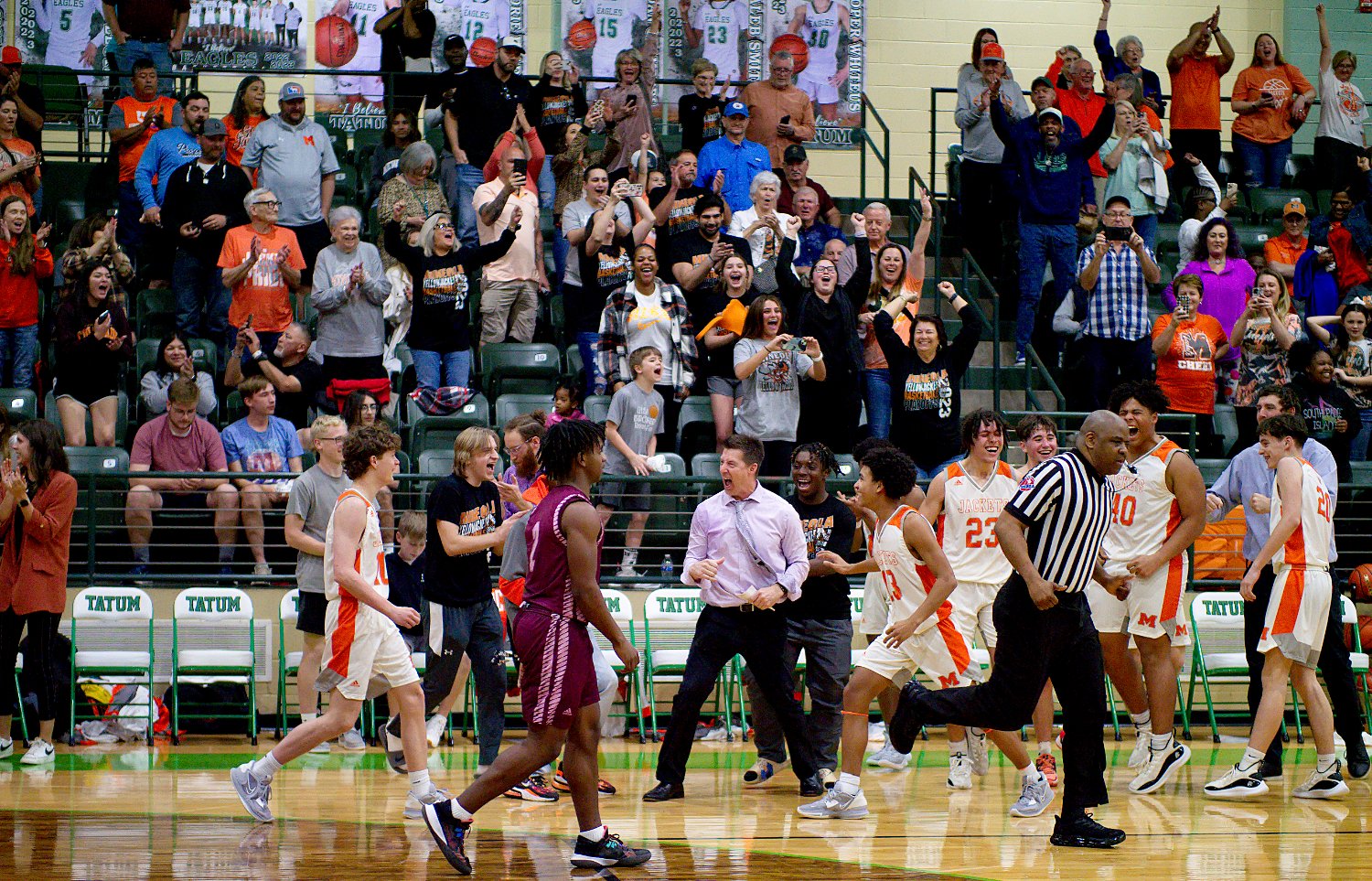 Mineola reacts to winning their regional quarterfinal matchup Tuesday against Atlanta in Tatum. [see more shots, buy basketball photos]